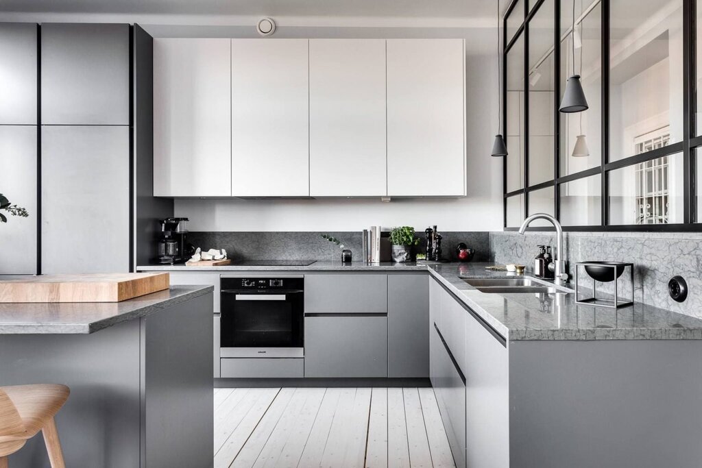 The kitchen is light gray with white