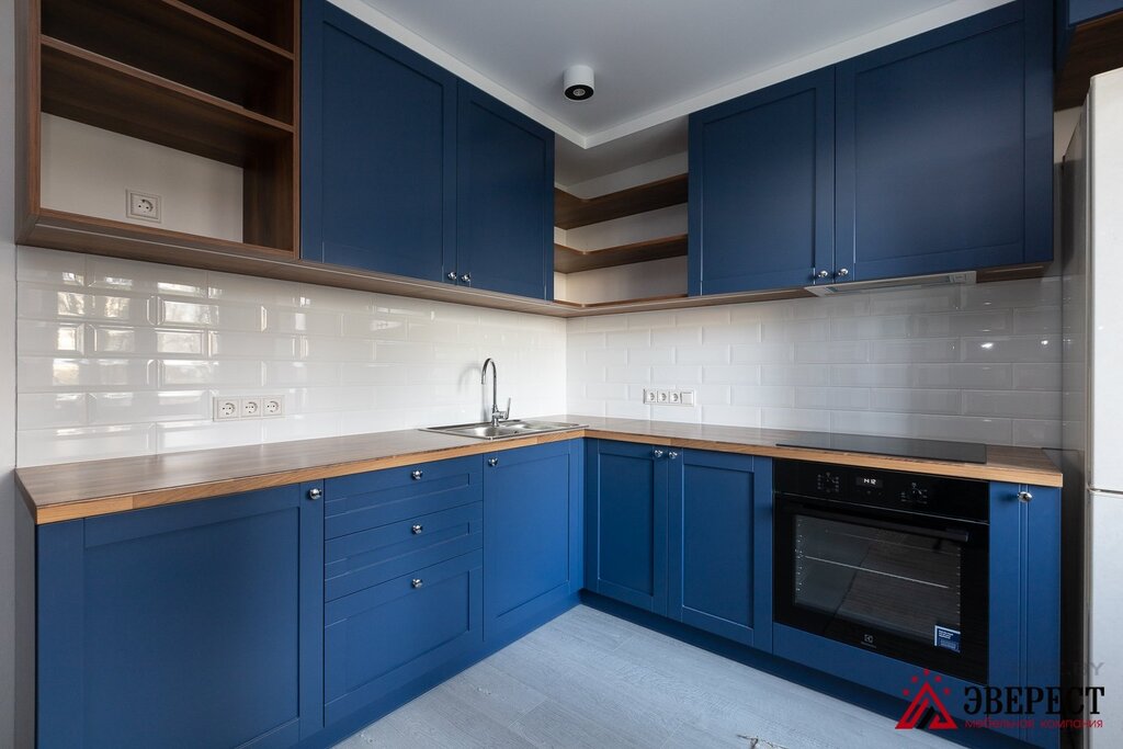 The kitchen is dark blue with white