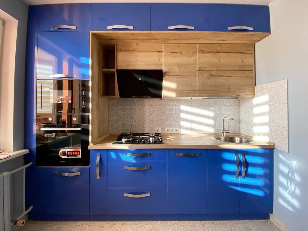 The kitchen is dark blue with wood