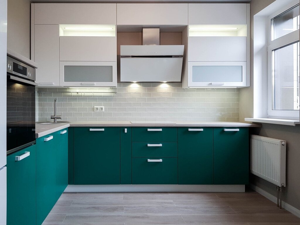 The kitchen has dark green lower cabinets and white upper cabinets