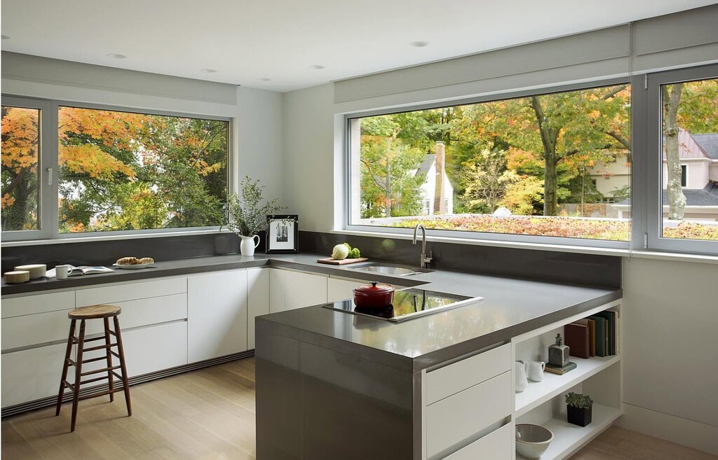 A kitchen set by the window in the house