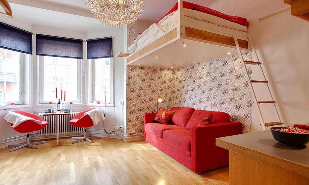 Studio apartment with a bed under the ceiling