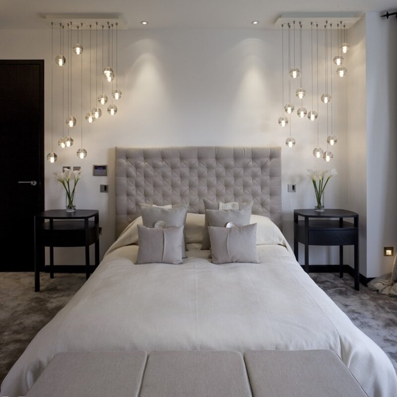 A chandelier above the bed in the bedroom