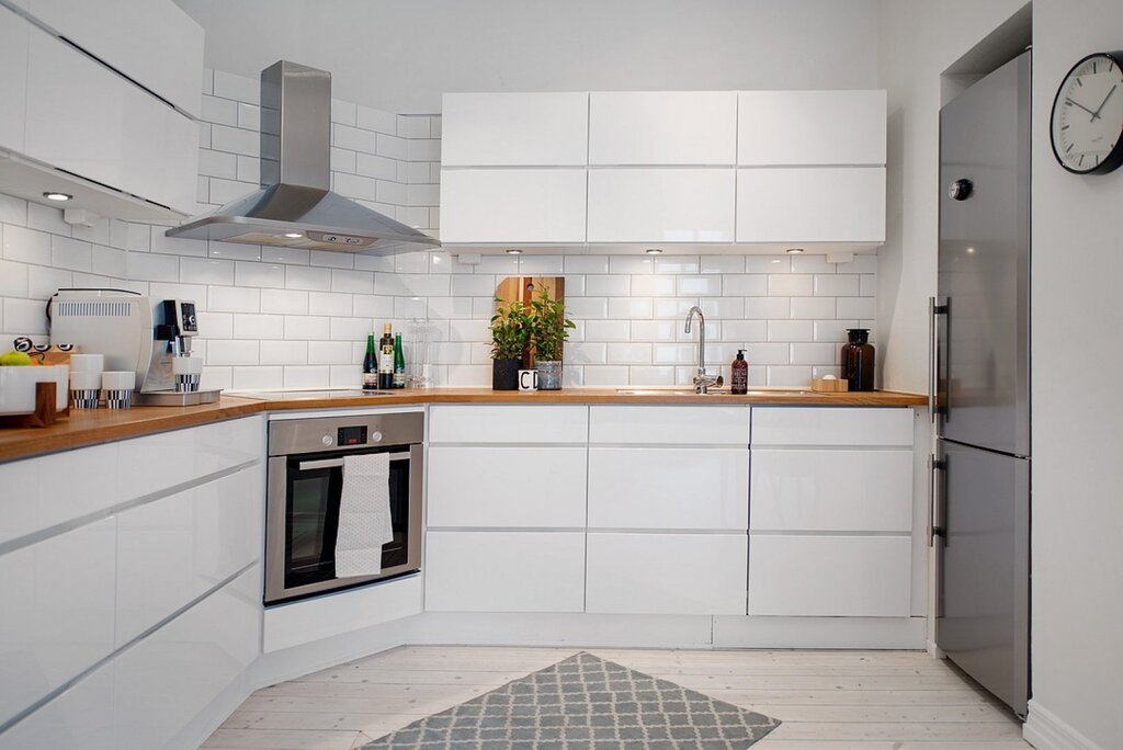 Small white kitchen with a wooden countertop