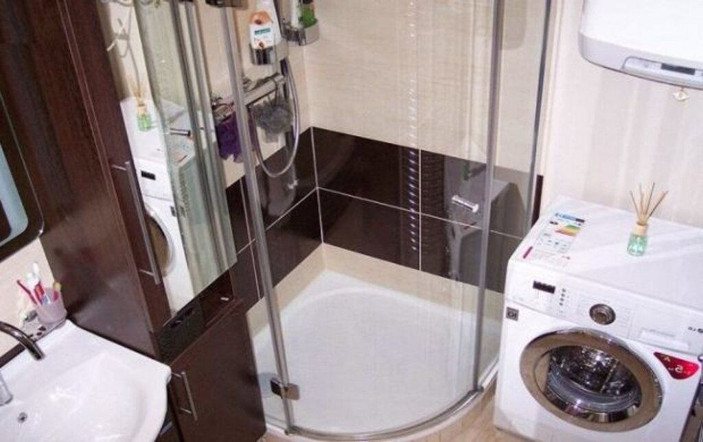 A small bathroom with a shower corner