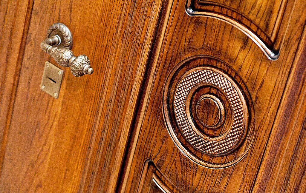 A metal door clad in wood