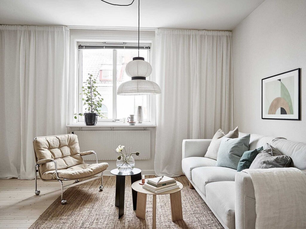 Milk-colored curtains in the living room interior