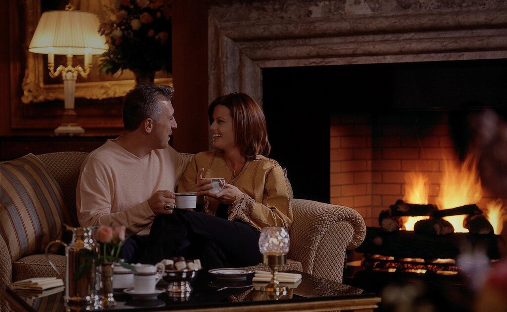 A man and a woman by the fireplace