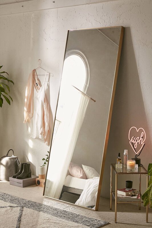 A floor mirror in the bedroom interior