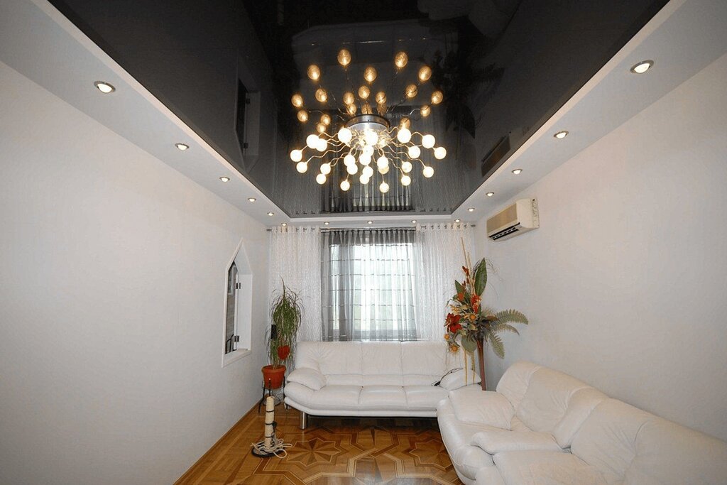 A stretch ceiling with lights and a chandelier