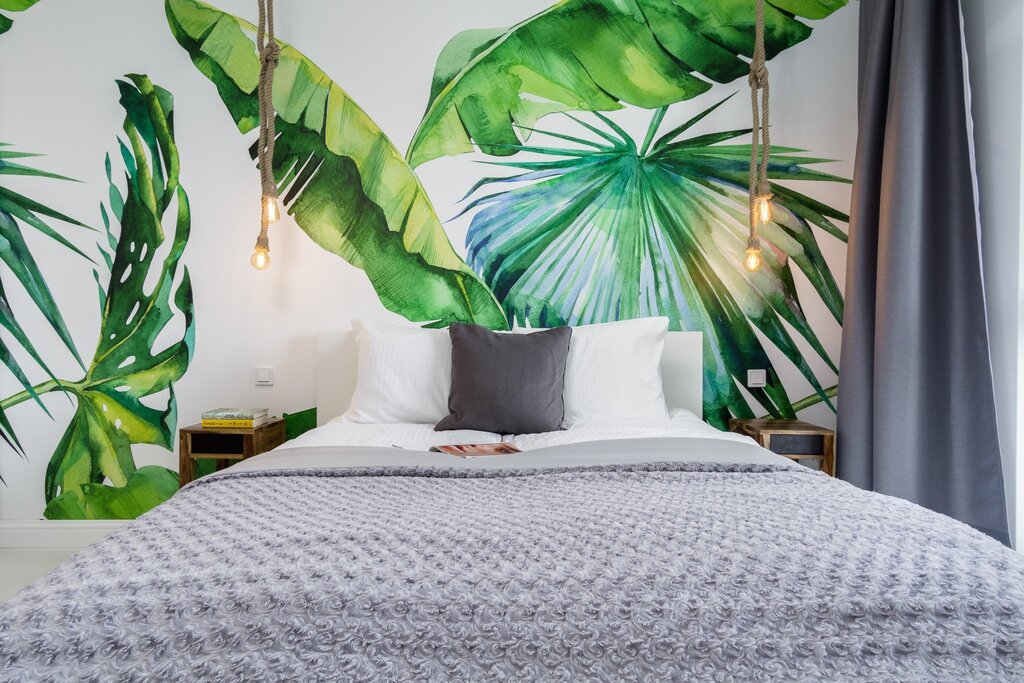 Wallpaper with palm trees in the bedroom interior