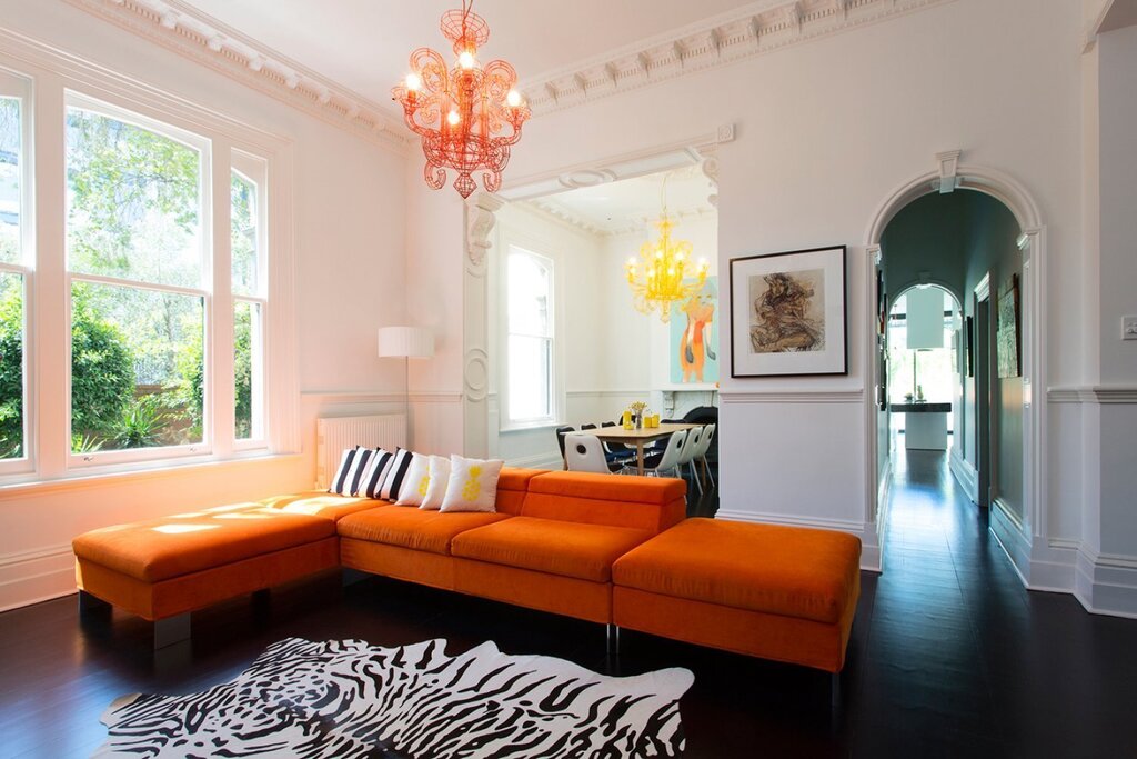 An orange sofa in the living room interior