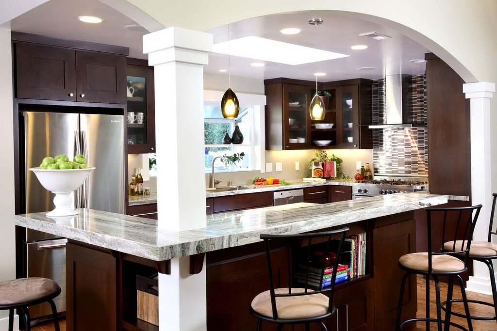 A kitchen island with a bar counter