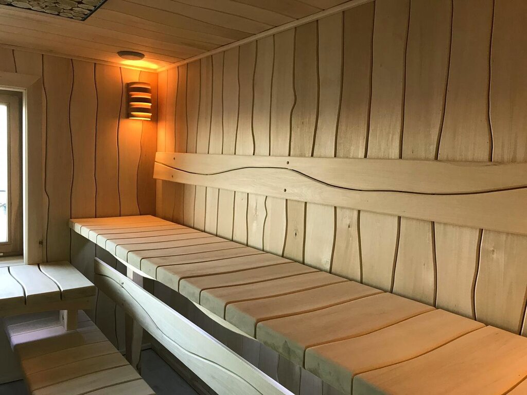 Interior finishing of a bathhouse with rough-cut planks