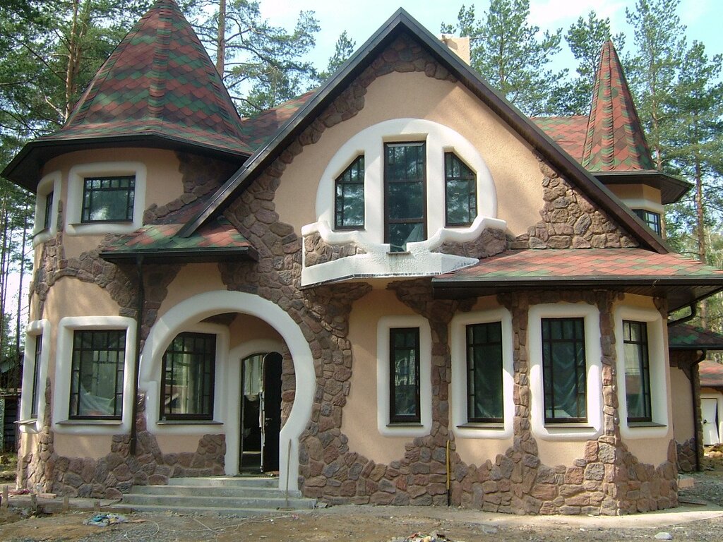 Finishing the facade with stone and plaster