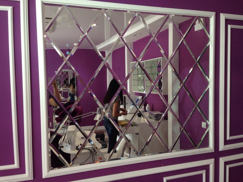 A panel made of mirrored tiles with a beveled edge