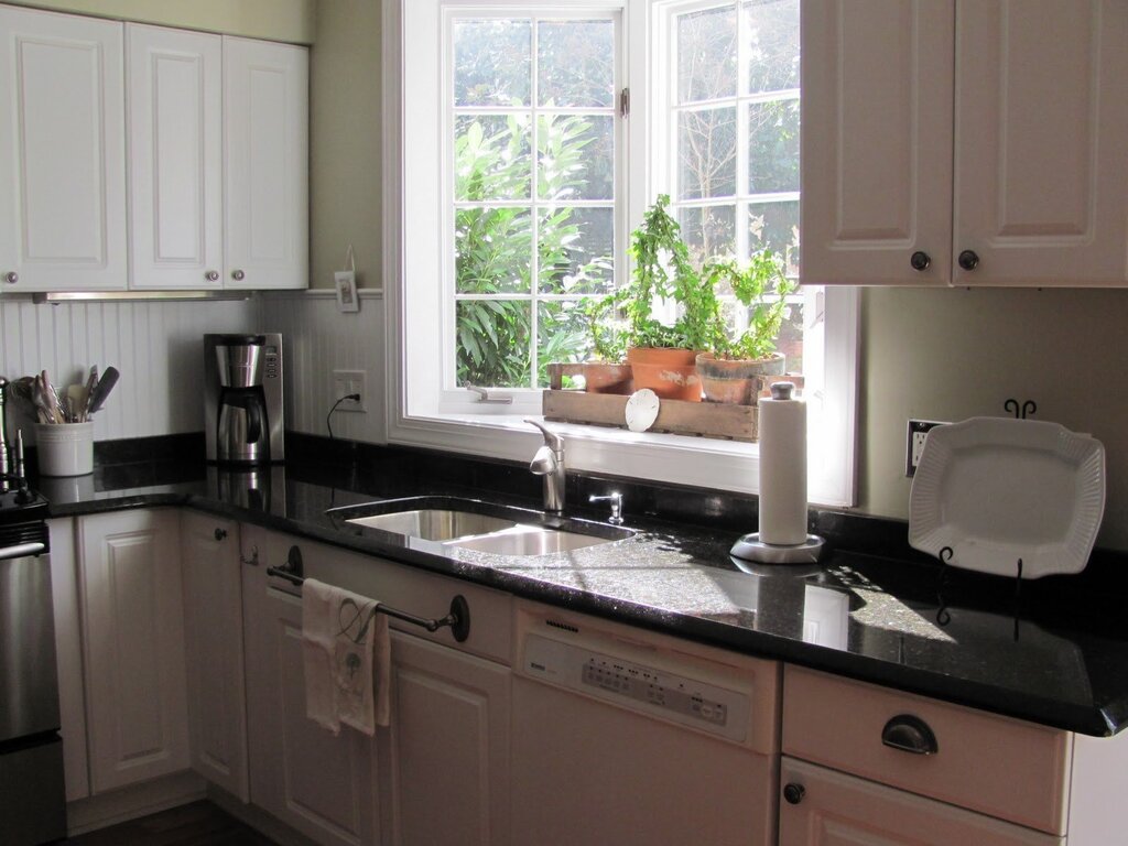 The sink by the window in the kitchen