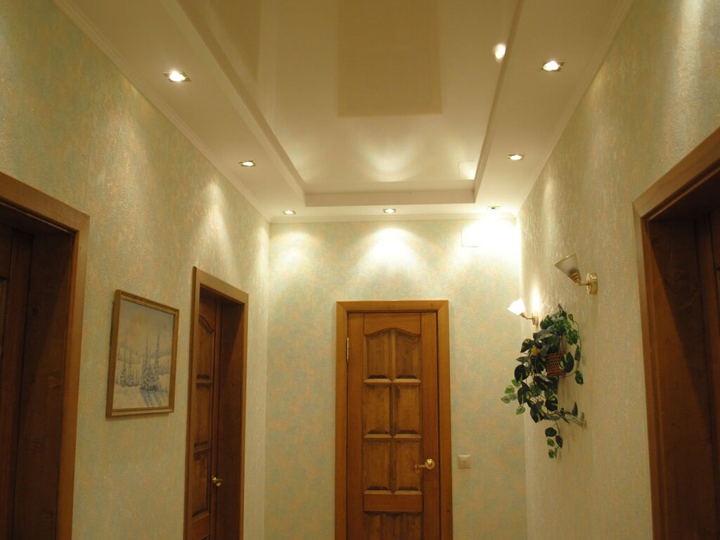 The placement of lights on the ceiling in the corridor