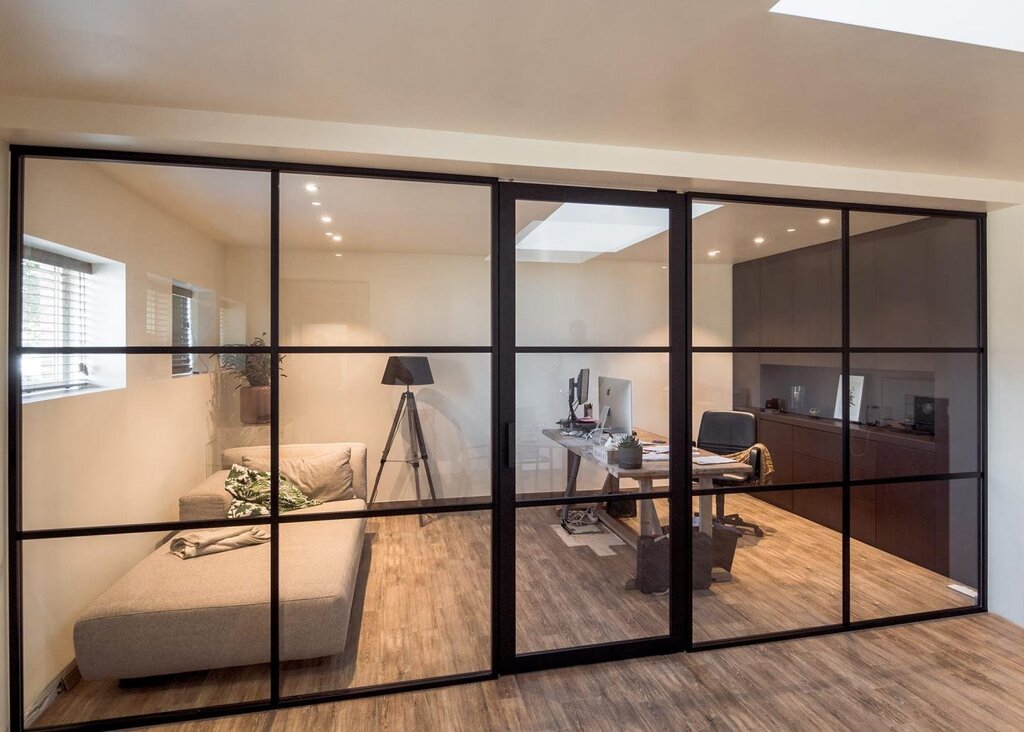 Sliding glass partition for a room