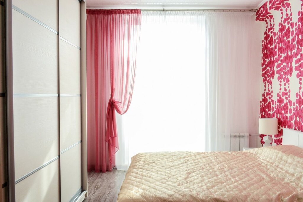 Pink curtains in the bedroom interior