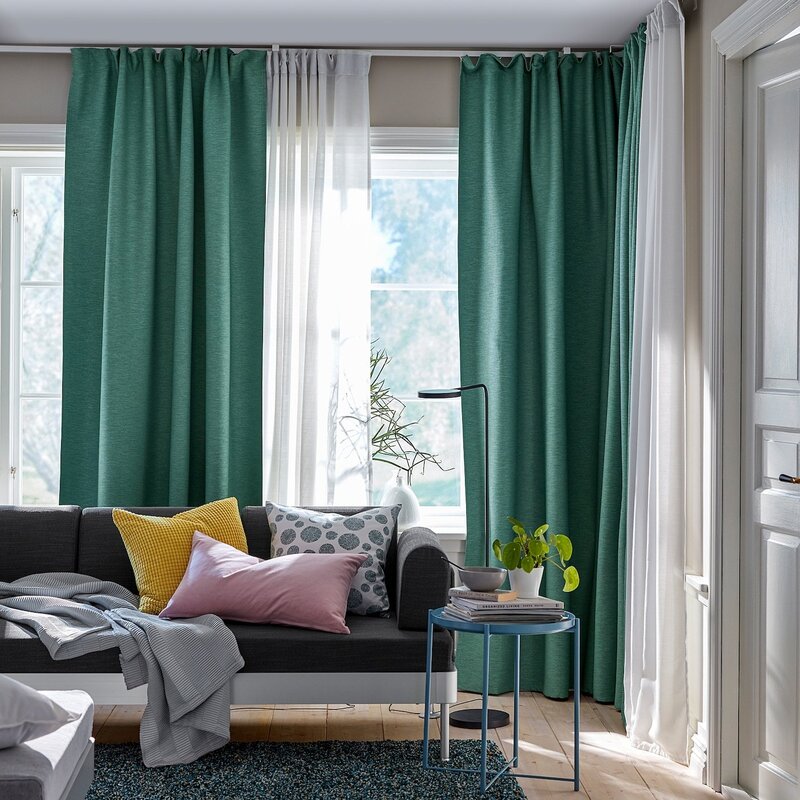 A gray room with green curtains