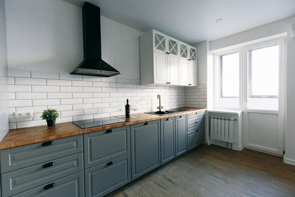 Gray and white kitchen with a wooden countertop