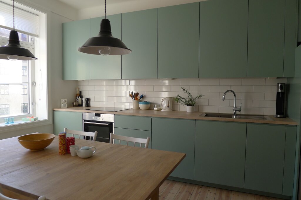 Gray-green kitchen with a wooden countertop