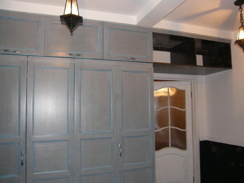 A cabinet with a mezzanine above the door