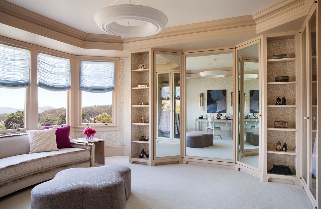 A cabinet with a mirror for the living room