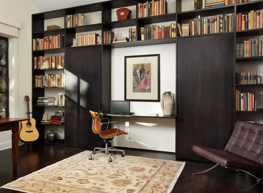 A cabinet in the living room with a workspace