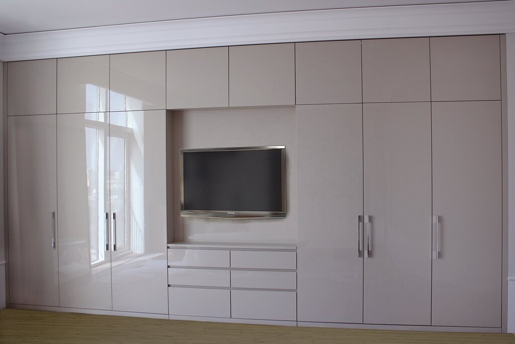 Sliding wardrobes in the living room with a TV 17 фото