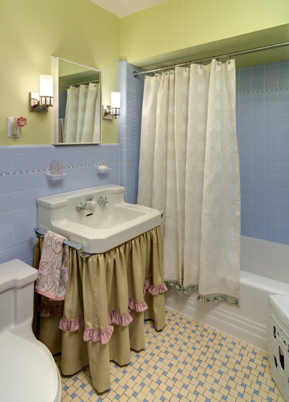 A curtain under the sink in the bathroom