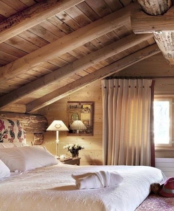 The bedroom in the attic of the wooden house