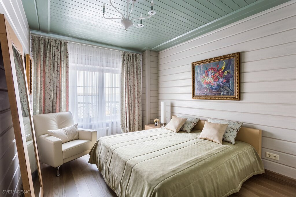 A bedroom finished with clapboard