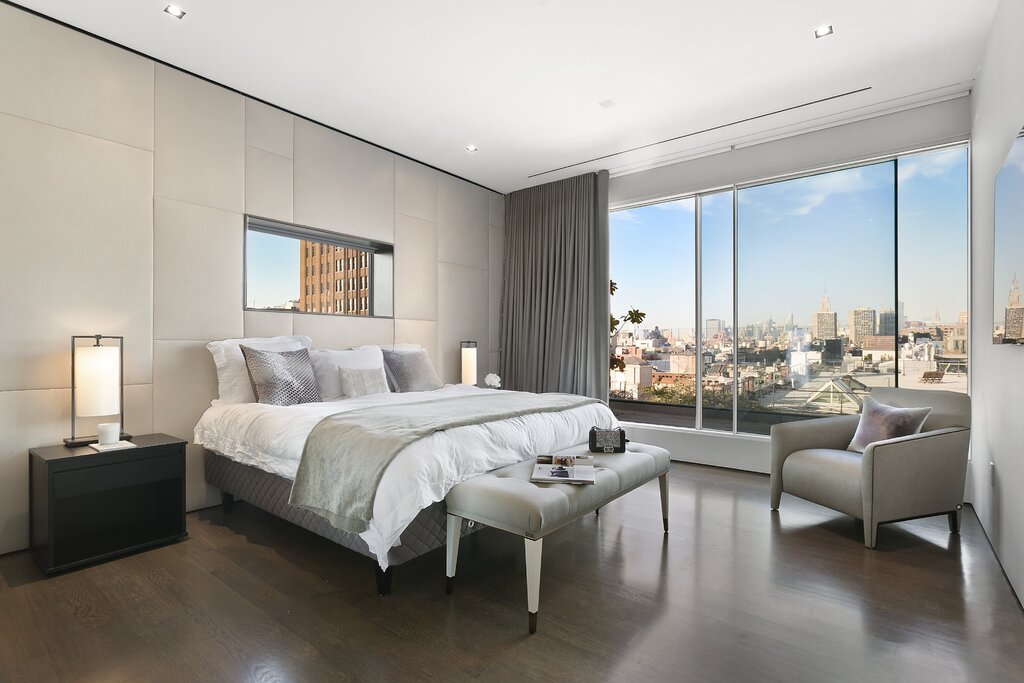 A bedroom with floor-to-ceiling windows