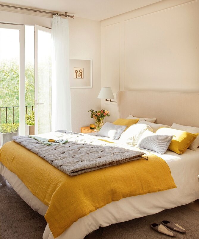 A bedroom with yellow accents