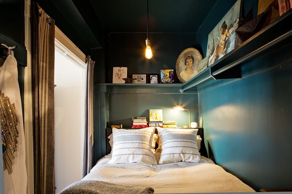 A bedroom in a closet without a window