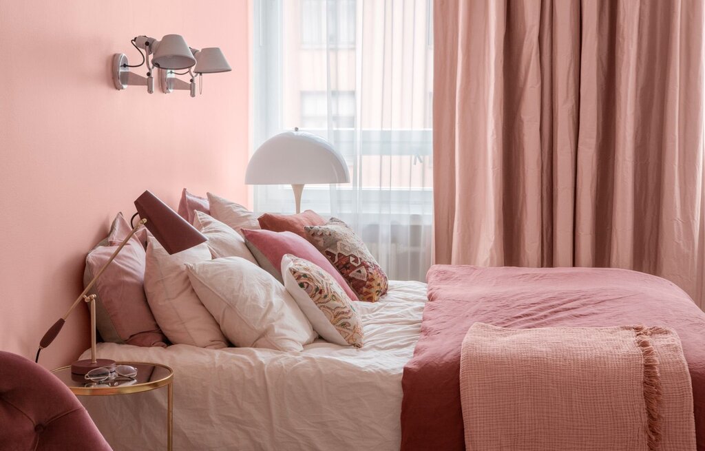 A bedroom in dusty rose color