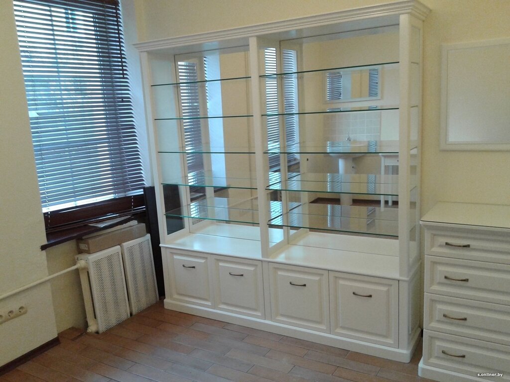 A shelving unit with glass shelves