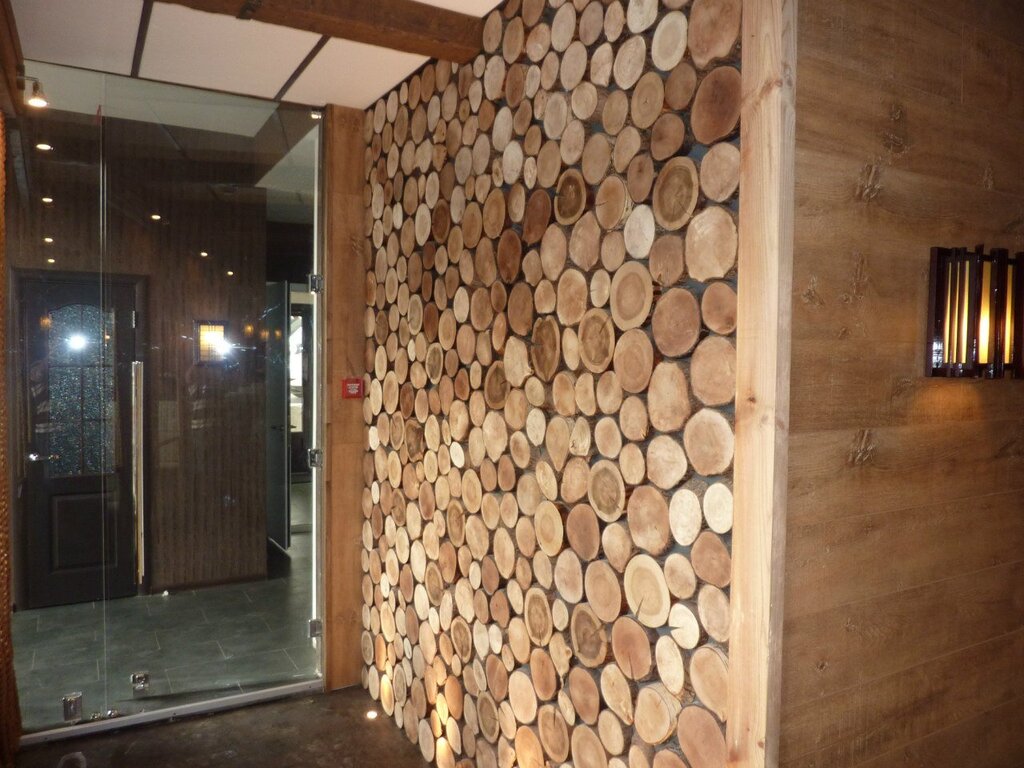 The walls in the sauna are made of wood slices