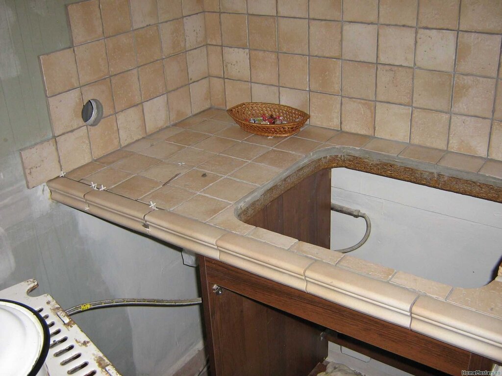 The countertop in the kitchen is made of tiles