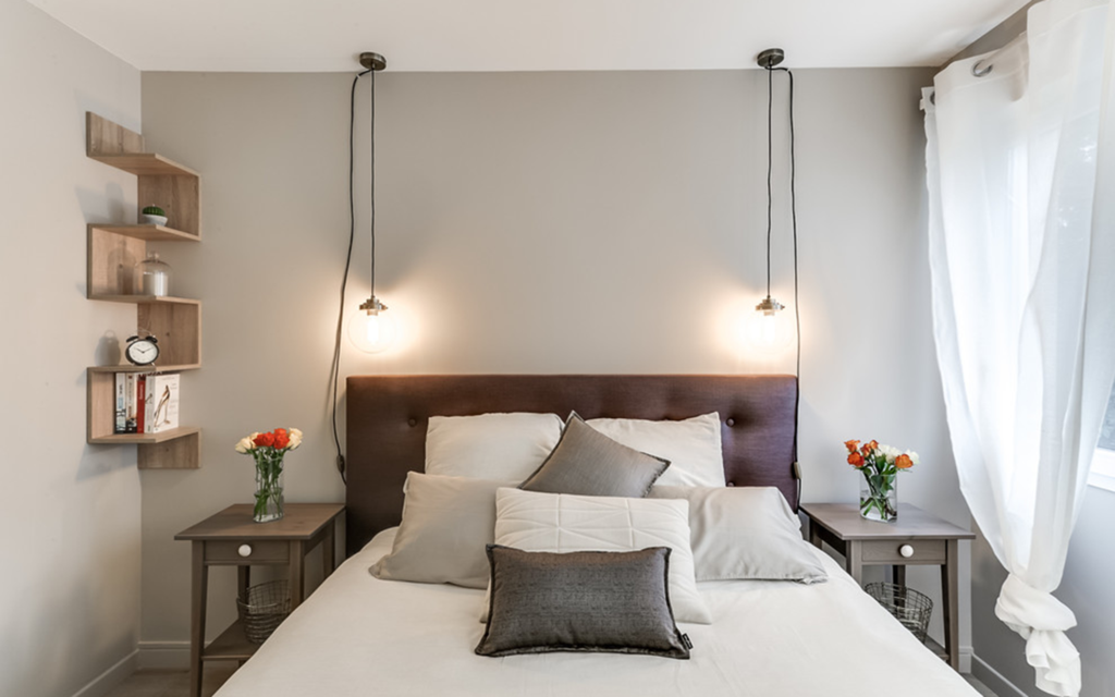 A lamp above the bedside table in the bedroom