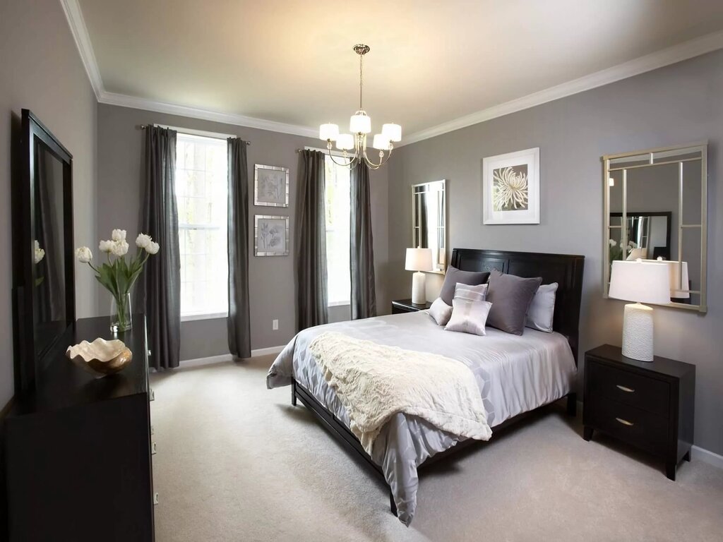 A bright bedroom with dark furniture