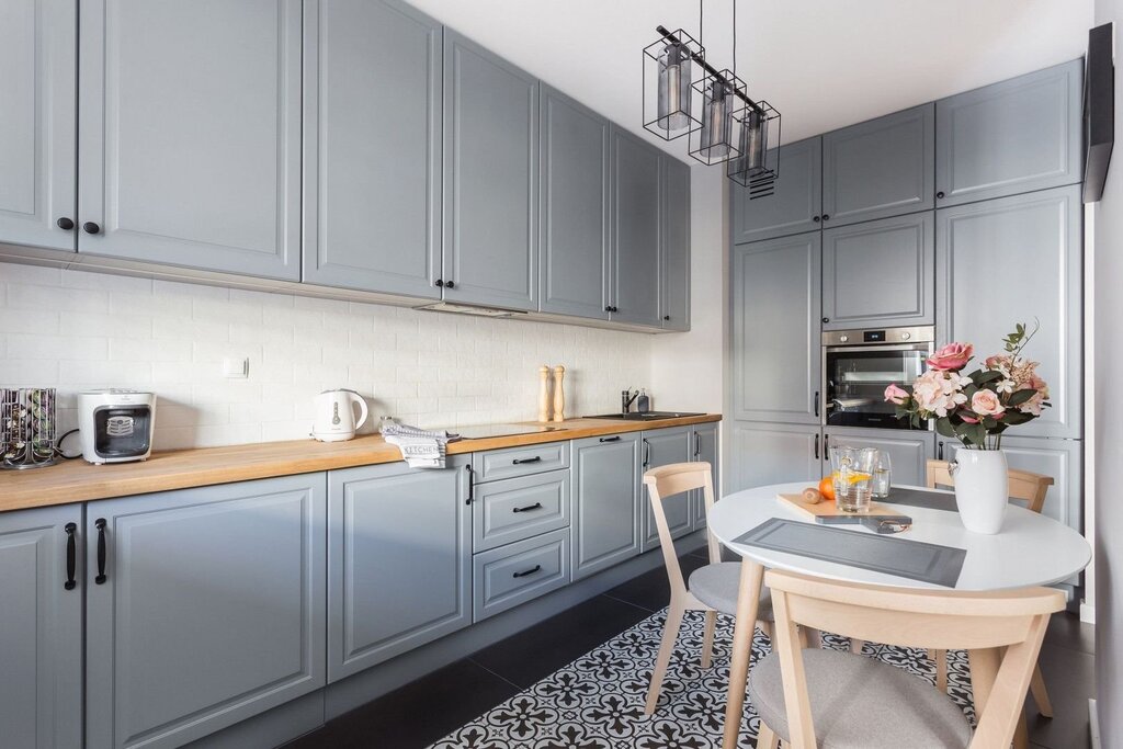 Light gray kitchen with a wooden countertop