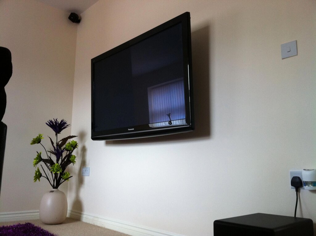 A TV on the wall without a bracket