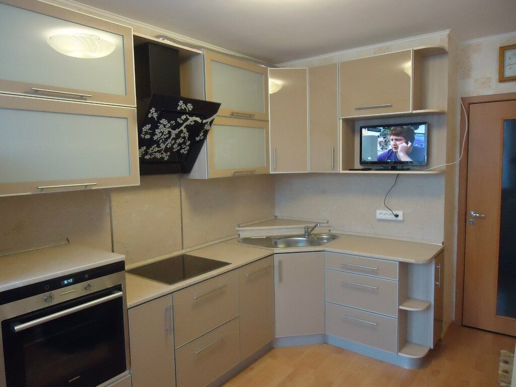 A television above the countertop in the kitchen