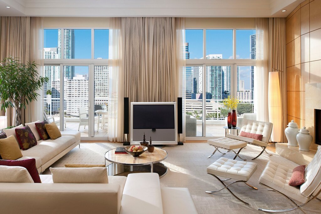 A television by the window in the living room interior