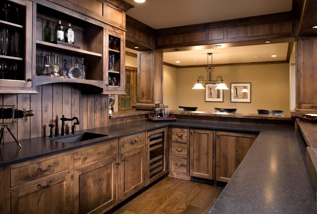 A dark kitchen with a wooden countertop