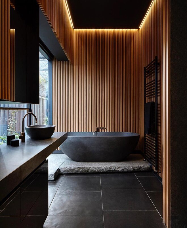 A dark bathroom with wood