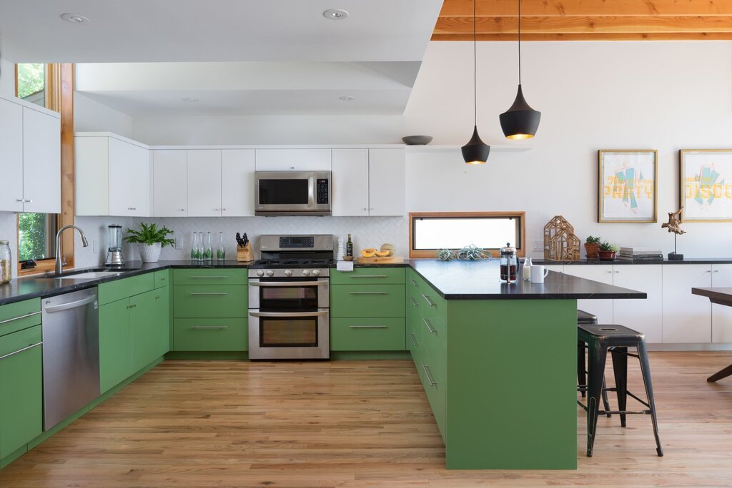 Dark green kitchen with a wooden countertop